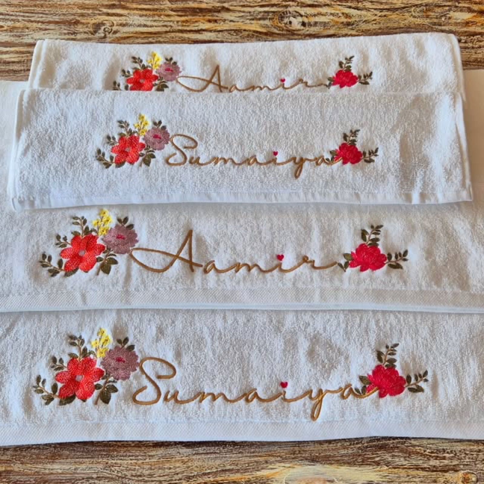 White Melchiah towels personalised with names and hand-drawn floral embroidery