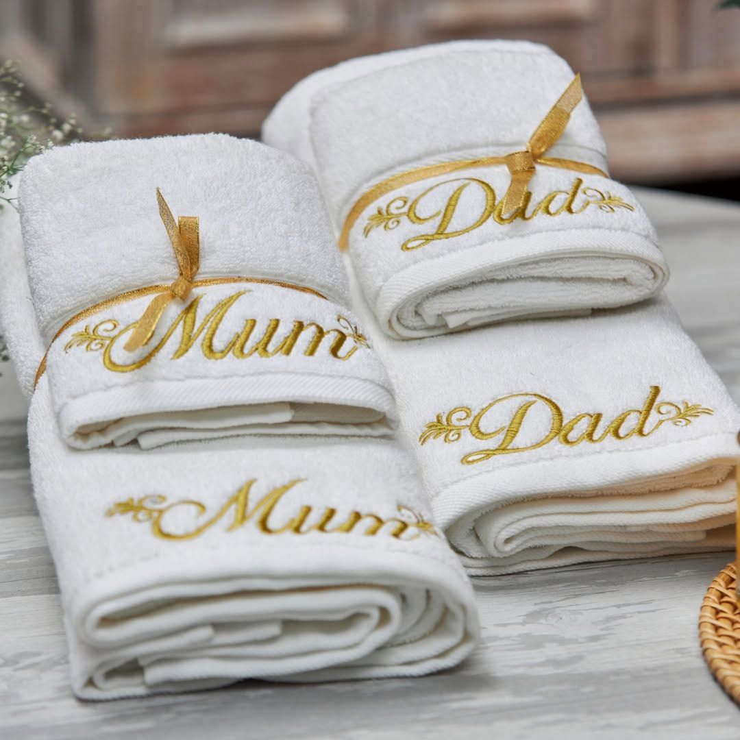 White Melchiah towels embroidered Mum and Dad in gold script