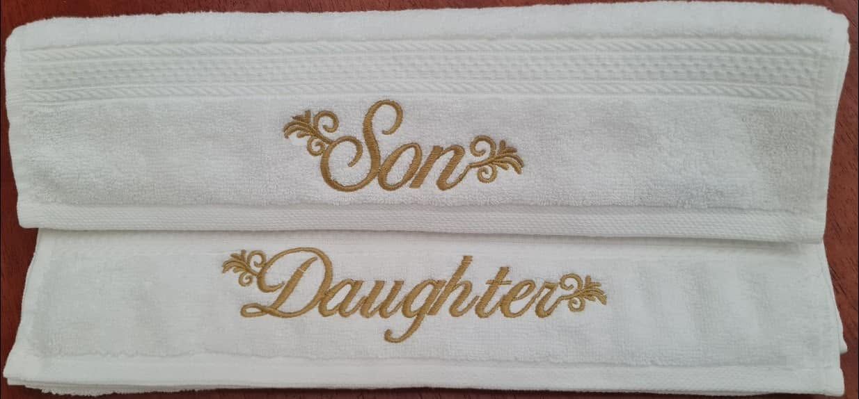 White Melchiah towels embroidered Son and Daughter in matching script