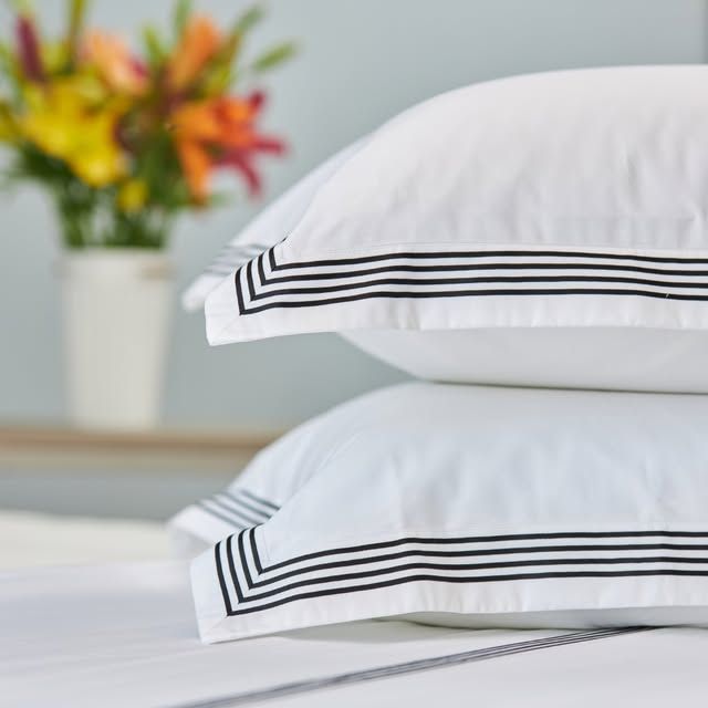 White Melchiah pillow shams finished with a fine tailored band
