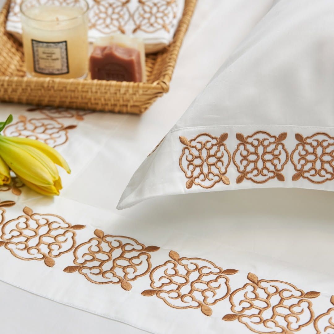 White Melchiah bedding embroidered with a copper trellis motif
