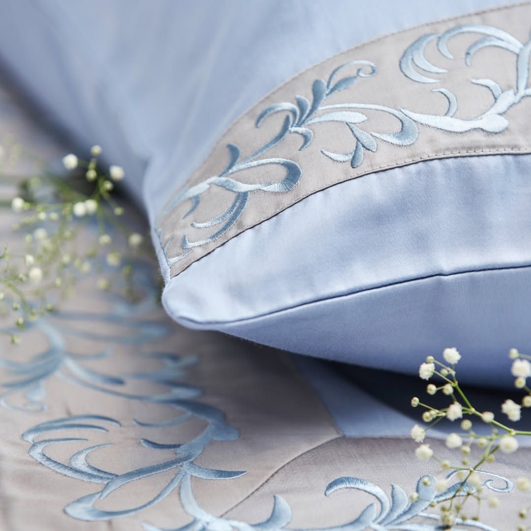 Powder blue Melchiah pillow embroidered with a floral motif