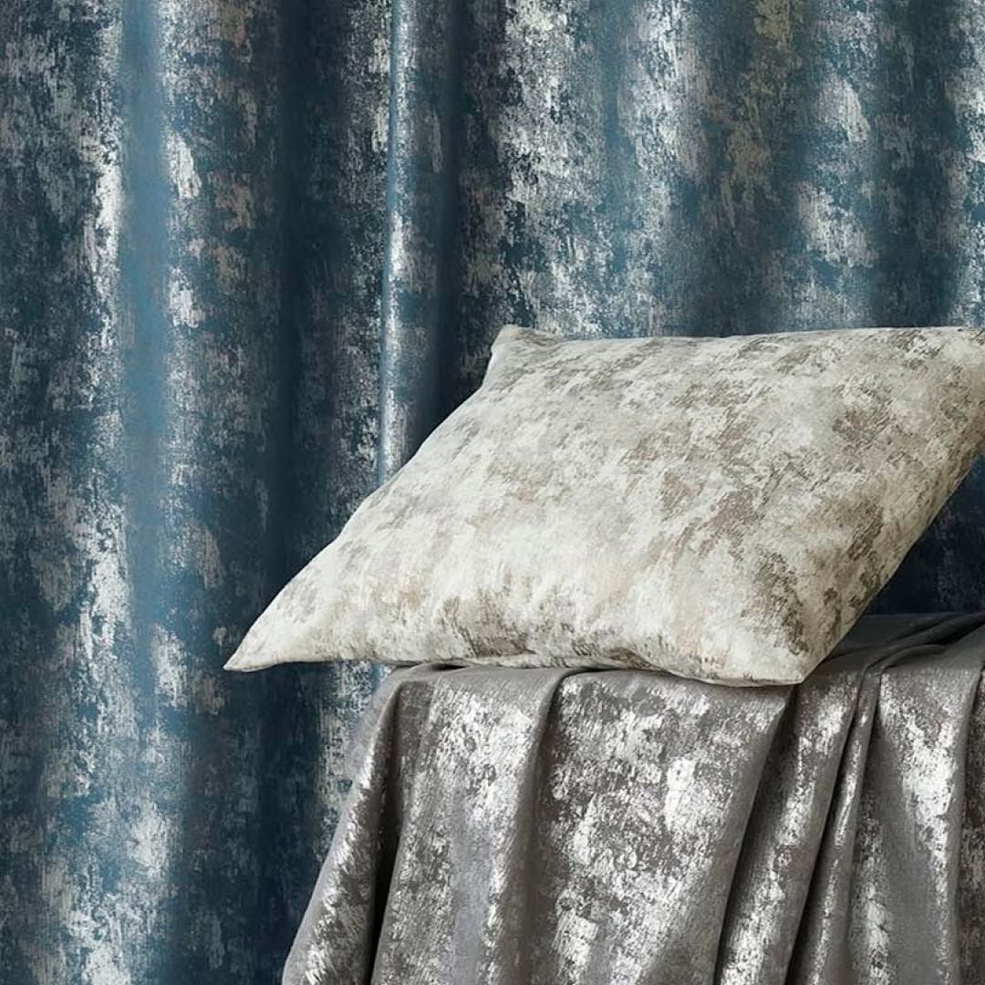 Deep teal Melchiah curtaining with a subtle brushed texture, styled with a cushion