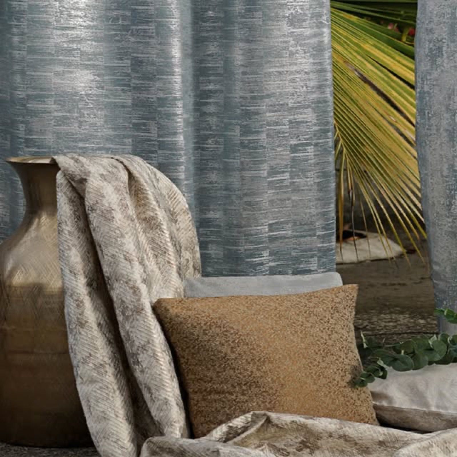 Slate-toned Melchiah curtains with a subtle woven texture, styled with cushions