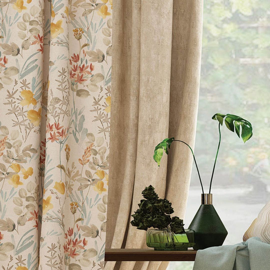 Melchiah curtain in a warm wildflower print styled in a sunlit corner