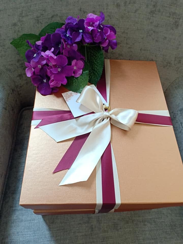 Dressed Melchiah gift box finished with a rose and amethyst ribbon