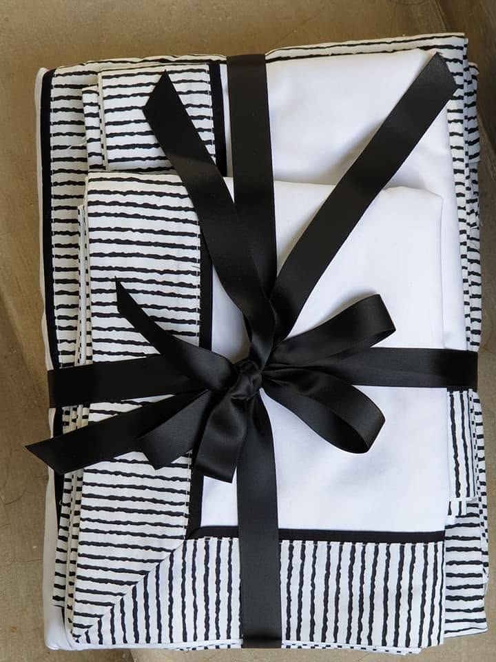 Delicate lace-edge Melchiah linen, ribbon-tied and ready to gift