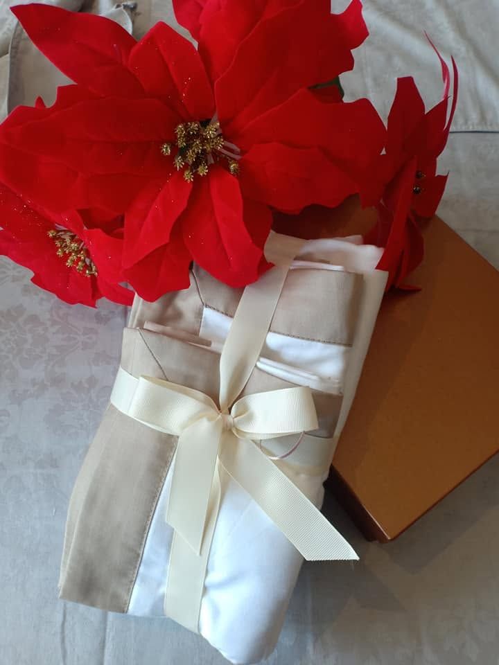 Festive Melchiah gift box styled with poinsettia and ribbon