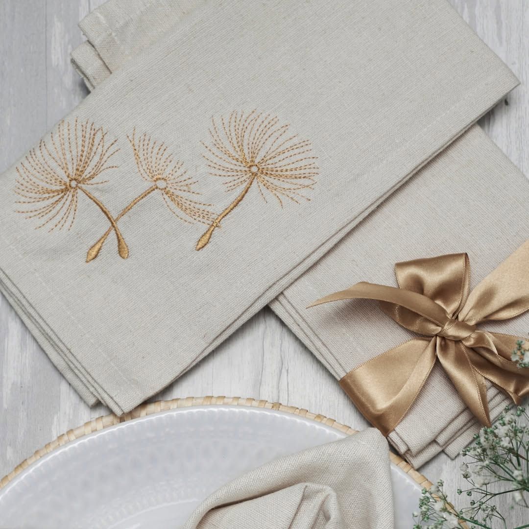 Melchiah napkins with fine gold embroidery finished with a satin bow
