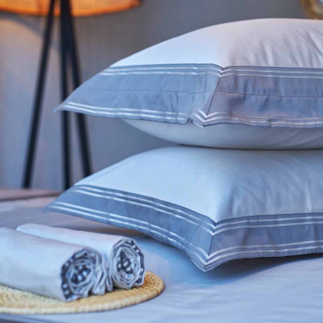 Melchiah white bed linen and pillows with tailored blue-grey borders